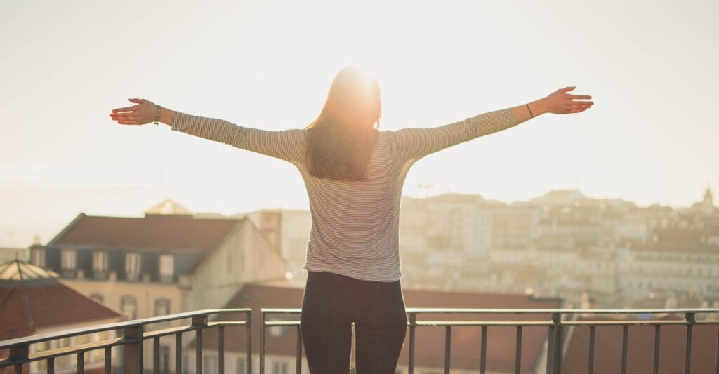 woman on balcony enjoying freedom
